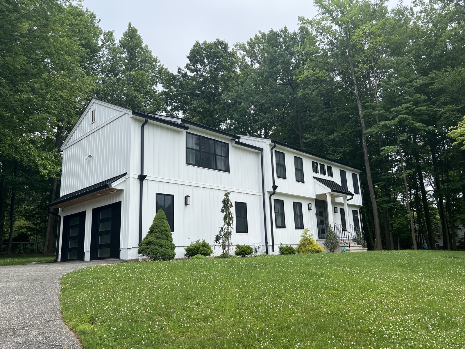 Modern white two-story home photographed from the front lawn